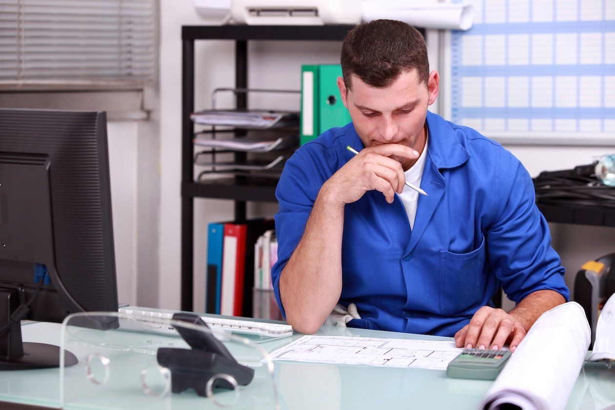 Restoration project manager reviewing job documentation and claim updates