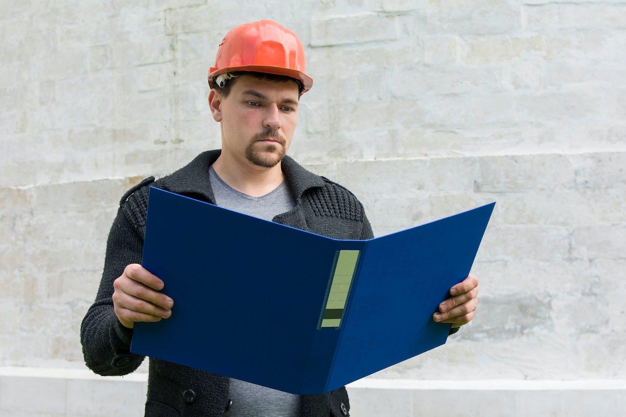 Restoration contractor checking job documentation.