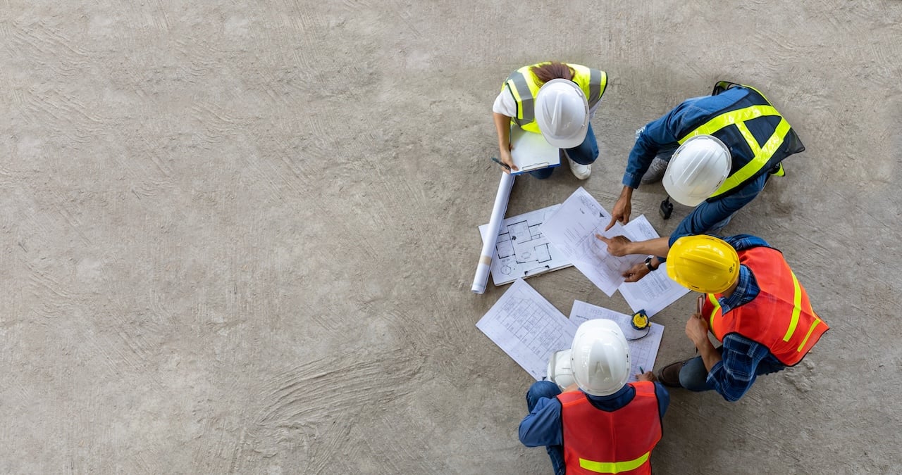 Restoration team reviewing job schedules and assignments at a planning meeting.