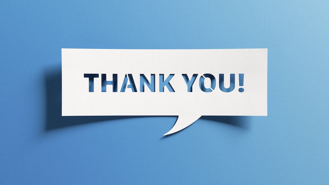Minimalist thank-you message design with white cut-out paper on a blue background, representing appreciation and acknowledgment in business relationships.
