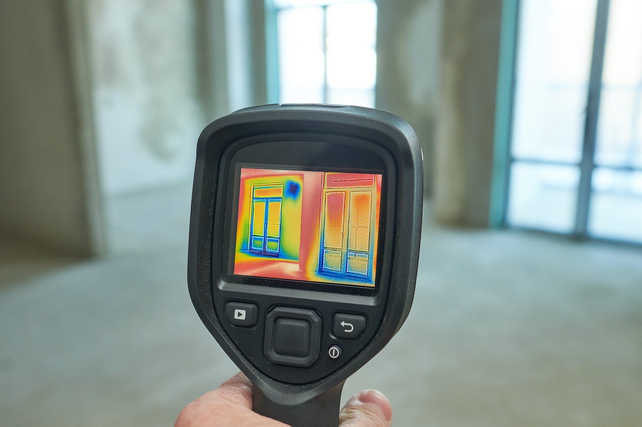 Using a thermal imaging camera to inspect a window.