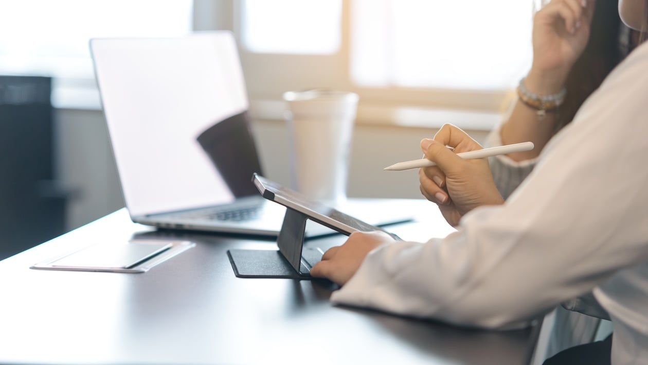 Team members reviewing project information together on a digital tablet